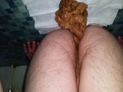 A hairy man urinating in the middle of the night on his bed